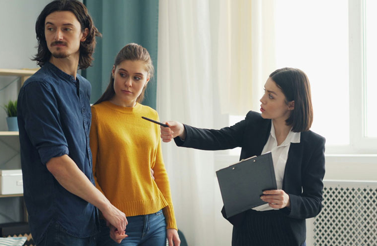 agent advising couple during viewing
